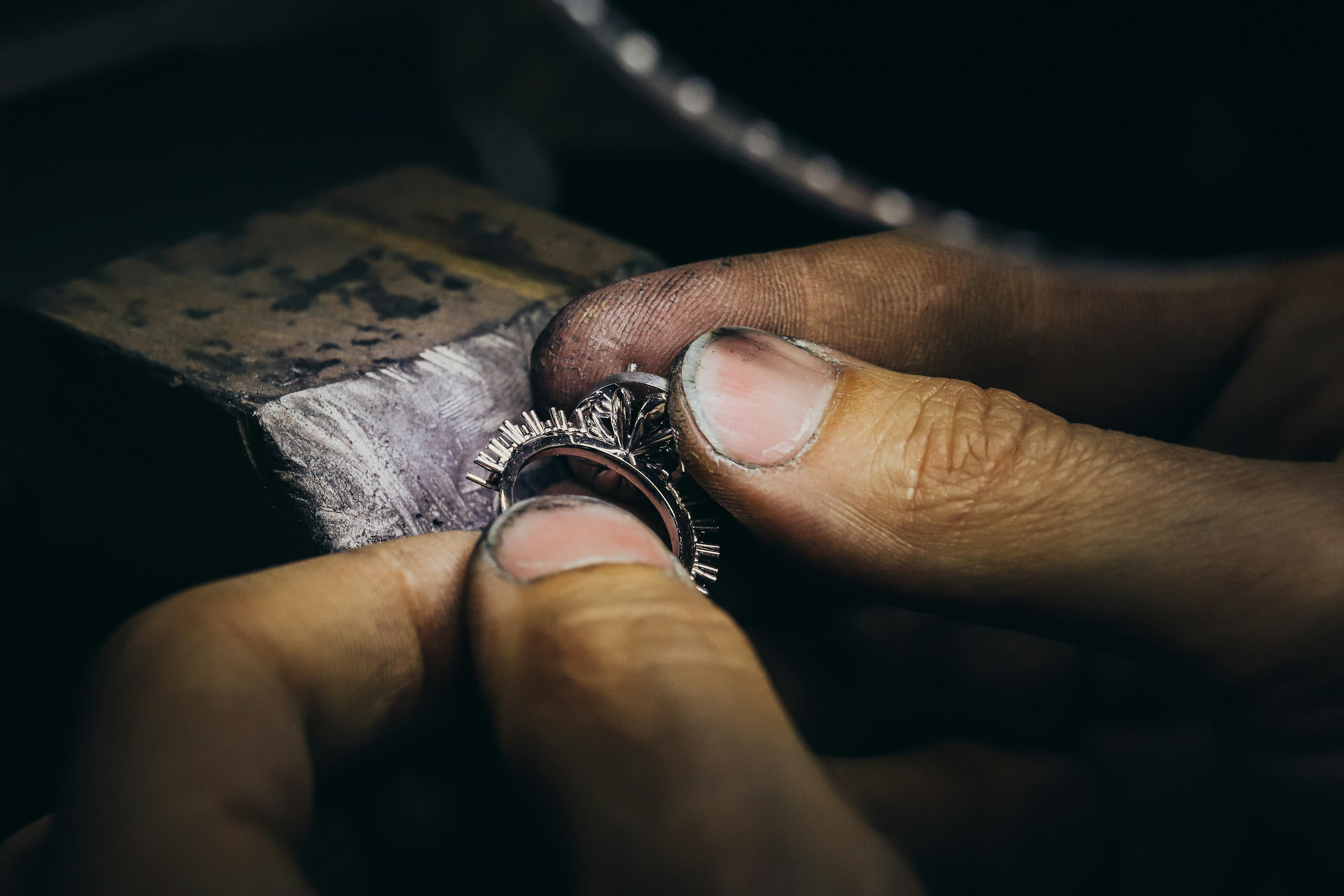 Silver ring being finished with precision by hand